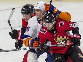 Ottawa Senators Mark Borowiecki (left) and Dylan DeMelo (right) check New York Islanders Brock Nelson during NHL action at the Canadian Tire Centre in Ottawa on Friday, October 25, 2019.