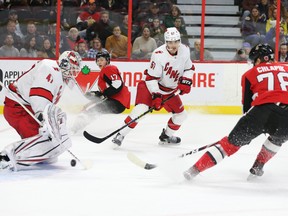 Senators’ Filip Chlapik (right) scores on Hurricanes goaltender James Reimer during the first period on Saturday night at Canadian Tire Centre. (WAYNE CUDDINGTON/POSTMEDIA NETWORK)