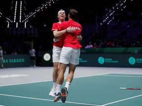 Canada's Vasek Pospisil and Denis Shapovalov celebrate after winning their doubles match against Russia's Karen Khachanov and Andrey Rublev.