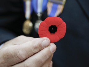 Sg. David Ratcliffe sells poppies in downtown Toronto on Friday November 8, 2019.