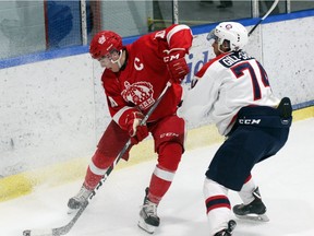 Pembroke Lumber Kings's captain Jacob Shankar battles in the corner for the puck against Ranvir Gill-Shane of the Ottawa Junior Senators