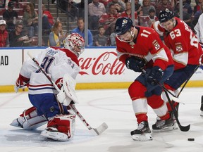 Panthers' Jonathan Huberdeau can't control the rebound given up by Canadiens' Carey Price as Evgenii Dadonov trails the play Sunday night in Sunrise, Fla.
