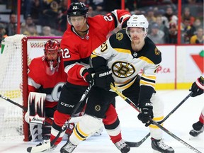 Nikita Zaitsev of the Ottawa Senators battles against Joakim Nordstrom of the Boston Bruins during second period of NHL action at Canadian Tire Centre on Monday night.