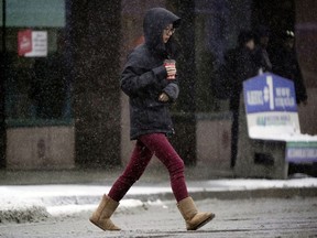 A woman scurries across the street.