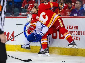 Calgary Flames right wing Michael Frolik (67) and Toronto Maple Leafs defenceman Morgan Rielly (44) battle for the puck during the first period at Scotiabank Saddledome. Mandatory Credit: Sergei Belski-USA TODAY Sports