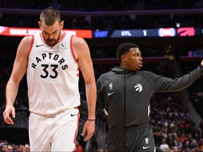 Raptors’ Kyle Lowry helps Marc Gasol off the floor in the first quarter against the Pistons in Detroit last night. Gasol injured his hamstring and didn’t return to the game. USA TODAY Sports