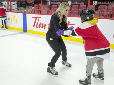 Alyssa Tremblay from the Ottawa Senators helps a youngster learn to skate as they enjoy the 16th annual Eugene Melnyk Skate for Kids at Canadian Tire Centre on Friday, Dec. 20.