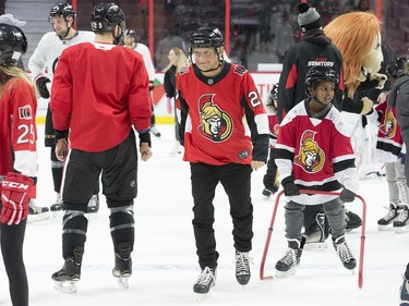 Ottawa Senators owner Eugene Melnyk (centre) skates with over 100 children at his 16th annual Eugene Melnyk Skate for Kids at Canadian Tire Centre on Friday, Dec. 20.