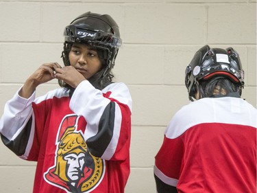 Shama ties up her helmet as kids get ready in the dressing rooms as Ottawa Senators owner Eugene Melnyk hosted over 100 children at the 16th annual Eugene Melnyk Skate for Kids at Canadian Tire Centre on Friday, Dec. 20.