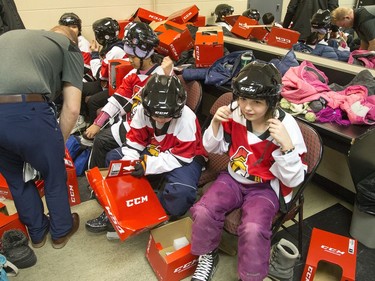 Kids get ready in the dressing rooms as Ottawa Senators owner Eugene Melnyk hosted over 100 children at the 16th annual Eugene Melnyk Skate for Kids at Canadian Tire Centre on Friday, Dec. 20.