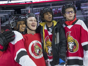 Brady Tkachuk poses with a group of youngsters as Ottawa Senators owner Eugene Melnyk hosted over 100 children at the 16th annual Eugene Melnyk Skate for Kids at Canadian Tire Centre on Friday, Dec. 20.