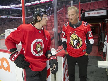 Ottawa Senators owner Eugene Melnyk chats with defenceman Thomas Chabot the 16th annual Eugene Melnyk Skate for Kids at Canadian Tire Centre on Friday, Dec. 20.
