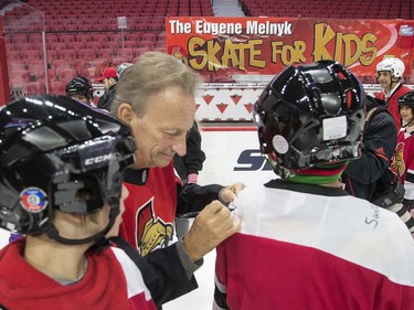 Ottawa Senators owner Eugene Melnyk signs some autorgraphs as he hosted over 100 children at the 16th annual Eugene Melnyk Skate for Kids at Canadian Tire Centre on Friday, Dec. 20.