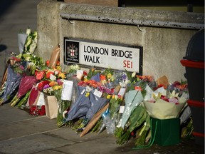 Bouquets of flowers are placed on London Bridge in memory of the victims of the attack in central London.