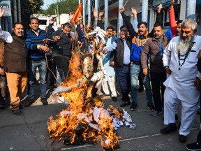 Activists from Shiv Sena Taksali shout slogans as they burn effigies of 'rapists' to protest against the alleged rape and murder of a 27-year-old veterinary doctor in Hyderabad, during a demonstration in Amritsar on Dec. 5, 2019. (NARINDER NANU/AFP via Getty Images)