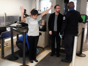 Transportation Security Administration agents check passengers at a security checkpoint at LaGuardia Airport in New York City, on Jan. 31, 2019.