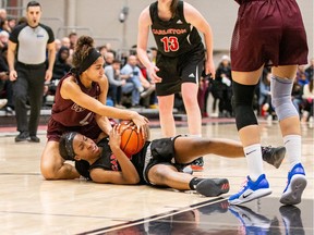 Brooklyn McAlear-Fanus, left, of the Ottawa Gee-Gees tries to pull the basketball away from Dorcas Buisa of the Carleton Ravens during an Ontario University Athletics women's basketball game at Carleton on Dec. 4, 2019.
Ottawa won the game 66-49. Valerie Wutti, Carleton Athletics