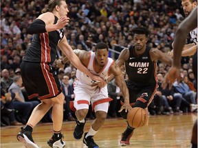 Miami's Kelly Olynyk, left, and Jimmy Butler put the squeeze on Toronto's Kyle Lowry in the second half of Tuesday night's contest.