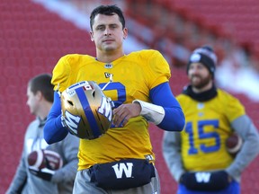 Winnipeg Blue Bombers QB, Zach Collaros with fellow QB Matt Nichols (15) in the background during practice at McMahon stadium in preparation for the 107th Grey Cup in Calgary, last month.