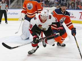 Ottawa Senators forward Connor Brown and Edmonton Oilers defensemen Ethan Bear chase a loose puck during the second period at Rogers Place.