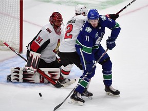 Canucks forward Zach MacEwan (71) tips a shot past Senators goaltender Anders Nilsson for one of four Vancouver goals in the first period of Tuesday's game.