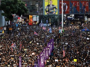 Protesters attend a Human Rights Day march, organized by the Civil Human Right Front, in Hong Kong on Sunday.