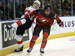 Canada's Alexis Lafreniere checks Switzerland's Dario Wuthrich during action in Victoria, B.C., on Wednesday, December 19, 2018. (THE CANADIAN PRESS/Chad Hipolito)