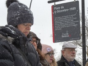 People attend the inauguration of a new sign at Dec. 6th Park on Thursday in Montreal — commemorating the 30th anniversary of the 1989 Ecole Polytechnique attack where a lone gunman killed 14 female students.