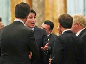 Prime Minister Justin Trudeau talks with others during a reception to mark 70 years of the NATO Alliance.