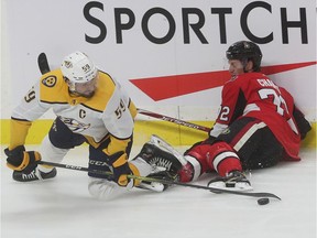 Ottawa Senators Thomas Chabot tries to get the puck from Roman Josi during second period action against the Nashville Predators at Canadian Tire Centre in Ottawa, Dec 19, 2019.