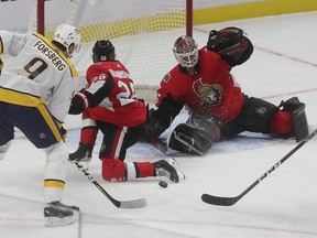 Senators goalie Marcus Hogberg gets some help as defenceman Erik Brannstrom blocks a shot by Nashville Predators’ Filip Forsberg on Thursday night at the Canadian Tire Centre. Anthony Duclair scored in OT. (TONY CALDWELL/OTTAWA SUN)