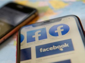 Facebook logos are seen on a mobile phone in this picture illustration taken December 2, 2019.