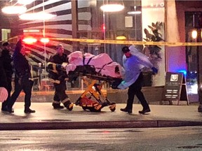 Emergency medical technicians and police rush to aid to a shooting victim in downtown Seattle on Wednesday night.