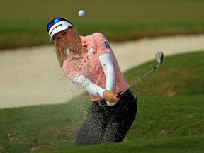 Canada’s Brooke Henderson plays out of the bunker during the first round of the Gainbridge LPGA at Boca Rio in Boca Raton, Fla., yesterday. Henderson is six shots off the lead.  Getty Images