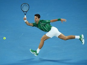 Novak Djokovic of Serbia plays a forehand during his men's singles quarterfinal match against Milos Raonic of Canada.