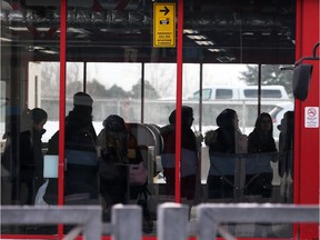 Passengers wait for the bus at the St. Laurent Station on Thursday after yet another delay.