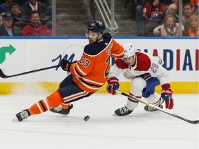 Edmonton Oilers' Riley Sheahan (23) battles Montreal Canadiens' Mike Reilly (28) during first period NHL hockey action at Rogers Place in Edmonton, on Saturday, Dec. 21, 2019.