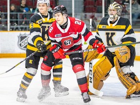 File photo/ Nikita Okhotyuk (28) of the 67's battles for position against Dawson Baker of the Frontenacs in front of the crease of goaltender Christian Propp.