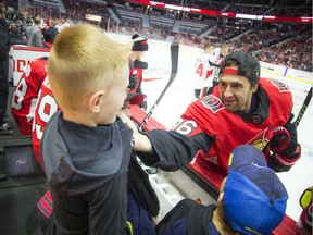 Colin White jokes around with the youngsters on the bench during the Ottawa Senators Skills competition that was held at the Canadian Tire Centre on Sunday.