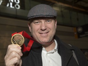 André Tourigny shows off his gold medal from the recent world junior hockey championship in tfhe Czech Republic upon arrival back at the Ottawa International Airport earlier this month.