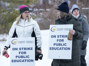 Teachers walk along Longfields Drive in Barrhaven as the OSSTF in Ottawa stages a one-day strike. Photo by Wayne Cuddington / Postmedia