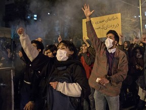 Iranians chant slogans and hold a placard reading in Farsi "Your mistake was unintentional, your lie was intentional" during a demonstration outside Tehran's Amir Kabir University on January 11, 2020. (Photo by STR/AFP via Getty Images)