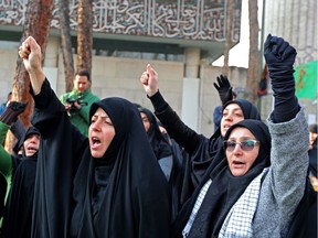 Supporters of the Basij, a militia loyal to the Islamic republic's establishment, chant anti-U.S. slogans during a memorial for the victims of the Ukraine plane crash in University of Tehran on Tuesday.