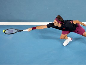 Roger Federer hits a return against Filip Krajinovic during their men's singles match on day three of the Australian Open tennis tournament in Melbourne on Wednesday.