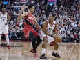 Raptors guard Kyle Lowry dribbles the basketball against defensive pressure by the Trail Blazers' Anfernee Simons during the fourth quarter of Tuesday night's game.