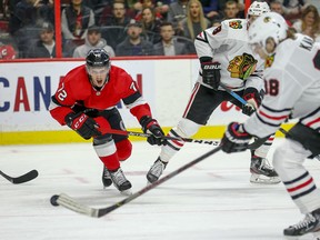 Senators defenceman Thomas Chabot hollers as Chicago Blackhawks’ Patrick Kane takes a shot during the second period on Tuesday night at the Canadian Tire Centre. (Wayne Cuddington/Postmedia Network)