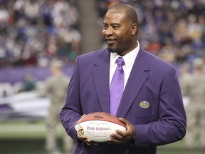 In this Dec. 15, 2013, file photo, former Minnesota Vikings star Chris Doleman acknowledges the crowd during a ceremony honouring the All Mall of America Field team in Minneapolis. (AP Photo/Andy King, File)