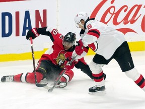 Ottawa Senators left wing Anthony Duclair and New Jersey Devils defenceman Connor Carrick battle for the puck at the Canadian Tire Centre, Dec. 29, 2019.