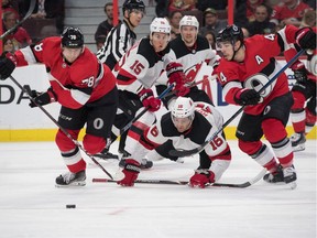 New Jersey Devils center Kevin Rooney (16) and John Hayden (15) follow the puck as Ottawa Senators center Filip Chlapik (78) and Jean-Gabriel Pageau (44) attack in the second period at the Canadian Tire Centre. on Monday.