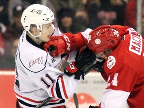 The Owen Sound Attack's Daylon Groulx, left, tussles with a Soo Greyhounds player in March 2019. The Ottawa 67's acquired Groulx in a trade on Jan. 9, 2020.